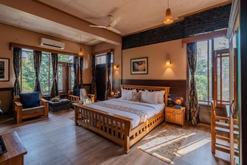 a bedroom with a bed in a room at SaffronStays The Divine Hima in Dharamshala