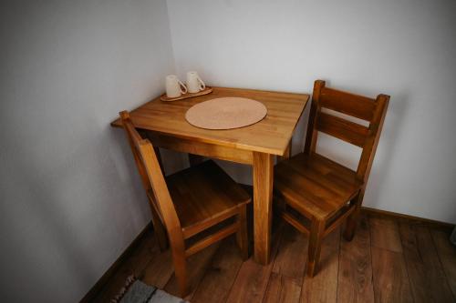 a wooden table and a chair next to a table and a table and a table at Villa Hope (Vila Speranta) in Băile Tuşnad