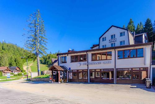 a large white building with a tree at Hotel Central Vlasic in Vlasic