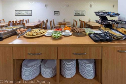 a table with plates of food on top at Hotel Central Vlasic in Vlasic