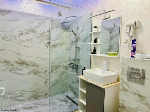 a bathroom with a shower and a sink at Seaview Studio in Năvodari