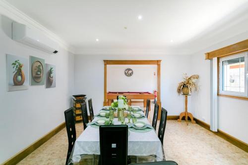 a dining room with a table with chairs and a table at GuestReady - O Segredo da Ilha in Ponta Delgada