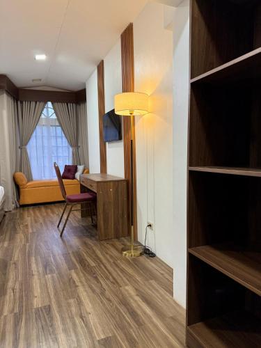a living room with a desk and a table in a room at Yuhum Bed & Breakfast in Bacolod
