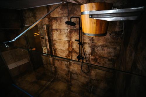 a shower in a brick wall with a shower head at Villa Hope (Vila Speranta) in Băile Tuşnad