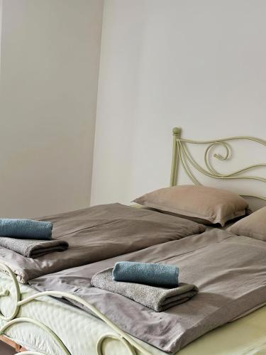 two beds with towels and pillows on them at Sobe PALMA in Sanski most
