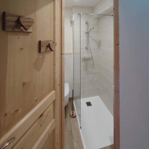 a bathroom with a shower and a toilet and a sink at Le Bellacha in La Léchère