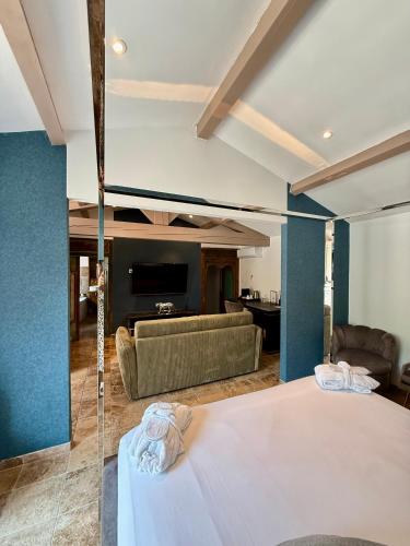 a bedroom with a large bed and a couch at La Villa Dune, Hôtel & Spa in Saint-Tropez