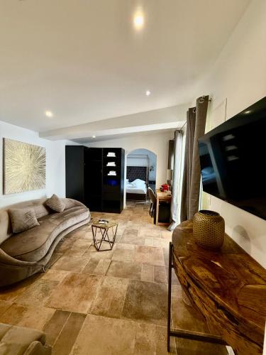 a living room with a couch and a table at La Villa Dune, Hôtel & Spa in Saint-Tropez