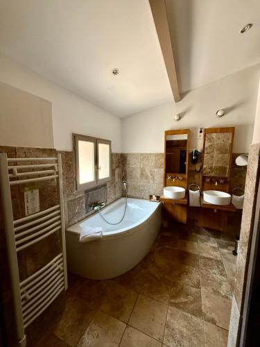 a large bathroom with a tub and two sinks at La Villa Dune, Hôtel & Spa in Saint-Tropez