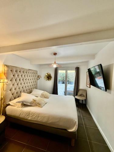 a bedroom with a large bed and a window at La Villa Dune, Hôtel & Spa in Saint-Tropez