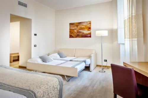 a living room with a couch and a table at Hotel Italia in Cagliari