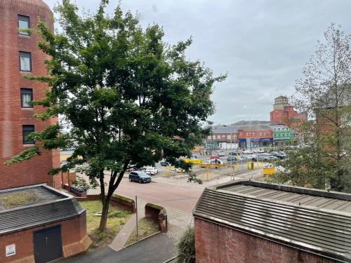 a tree on the side of a building with a street at Stylish City-Centre 1-Bed Flat in Wolverhampton