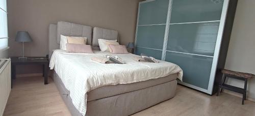 a bedroom with a large bed with a large headboard at holiday home Zonnestraal in Zonhoven