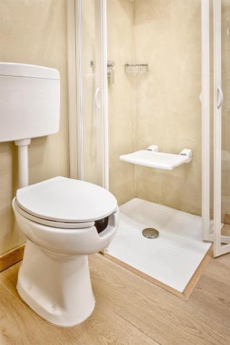 a bathroom with a toilet and a shower at Hotel Italia in Cagliari