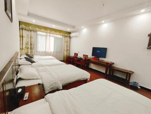 Postel nebo postele na pokoji v ubytování Dameng Hotel, Furong Town