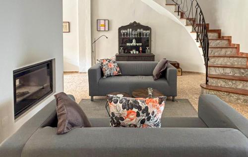 a living room with a couch and a fireplace at Gorgeous Home In Llaurí With Wifi in Llaurí