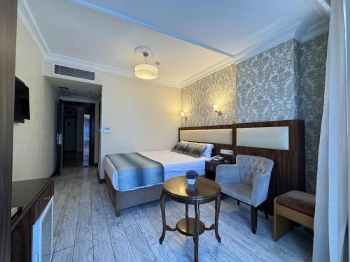 a hotel room with a bed and a table and a chair at Hotel Bulvar Istanbul in Istanbul