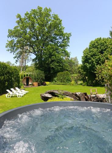 a hot tub in the middle of a yard at Leśny Dwór Bieszczady in Ustrzyki Dolne