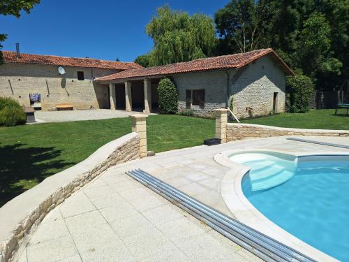 une piscine devant une maison dans l'établissement Gites Les Grandes Ecures, à Mons