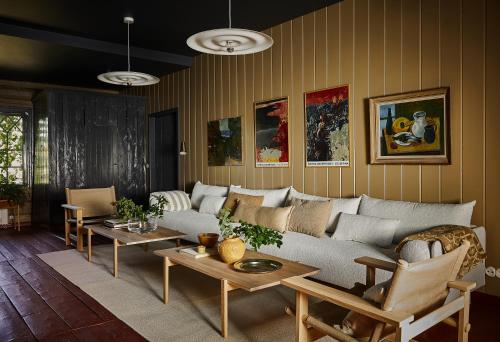 a living room with a couch and tables at Stay North Matri House Edla in Mathildedal