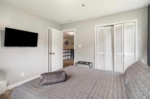 a bedroom with a bed and a flat screen tv at 5BR with Game Room & Huge Backyard in Lawrenceville