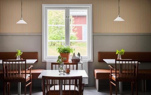 a restaurant with two tables and a window at Stay North Matri House Edla in Mathildedal