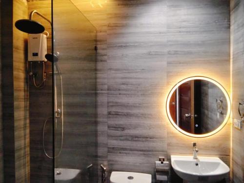 a bathroom with a sink and a mirror at Ola De Baler Hotel in Baler
