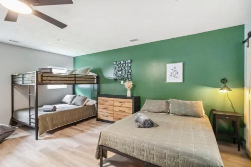 a bedroom with two bunk beds and a green wall at 5BR with Game Room & Huge Backyard in Lawrenceville