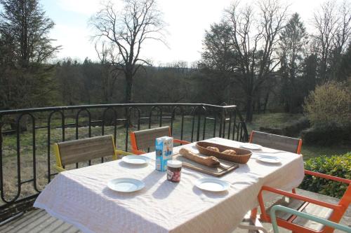 a white table with food on top of a balcony at Château Champêtre 8 chambres, parc 18 ha, 4 étangs in Fontenoy