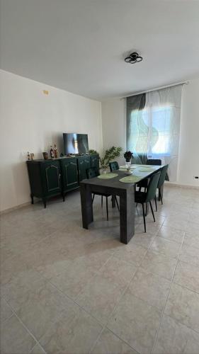 a dining room with a table and some chairs at La casa di Flo in Solanas