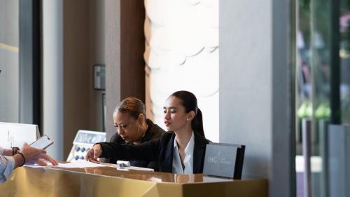 a group of people sitting at a table with a box at Kimpton Sawyer Hotel by IHG in Sacramento