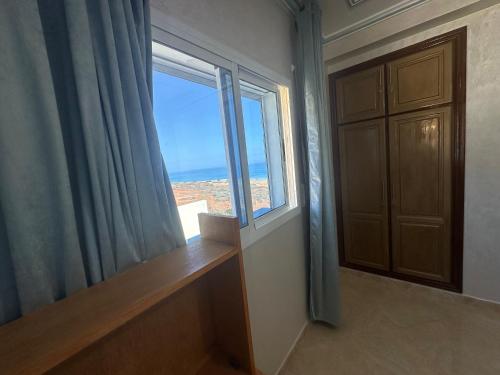 a room with a large window and a door at Villa MANSOURA in Driouch