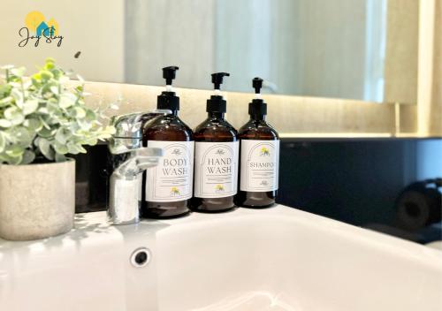 three bottles of wine sitting on top of a sink at The Shore l Luxury 3BR l 6-9pax l Direct Mall Access l City Centre l Melaka River l Jonker Street by Jay Stay Management in Melaka