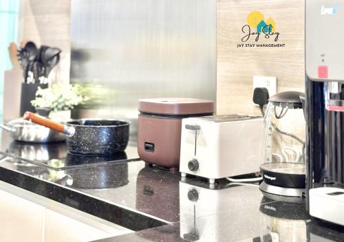 a kitchen counter with a coffee maker and a toaster at The Shore l Luxury 3BR l 6-9pax l Direct Mall Access l City Centre l Melaka River l Jonker Street by Jay Stay Management in Melaka