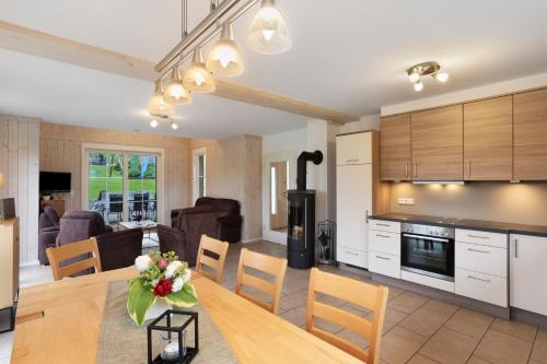 a kitchen and living room with a table and chairs at Ferienhaus Wasserfall in Bestwig
