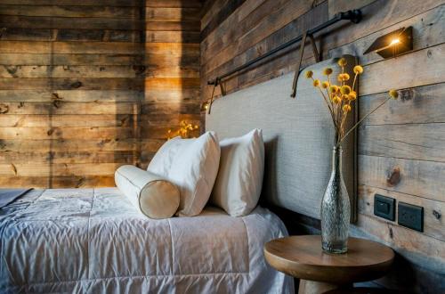 a bedroom with a bed with a vase of flowers at Las Cabañas by PMJ in Cayambe