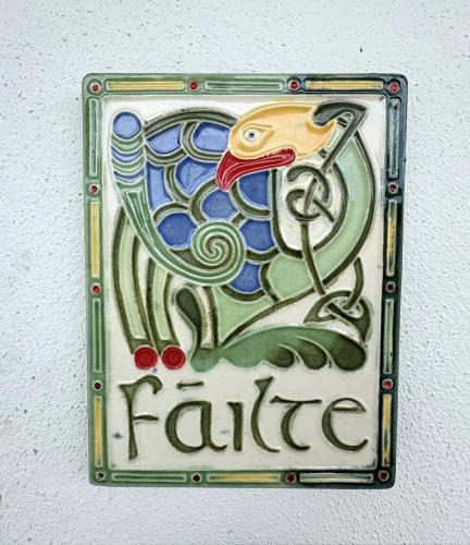 a sign with a fish on a wall at Comfortable Home in Quiet Coastal Community in Dungarvan