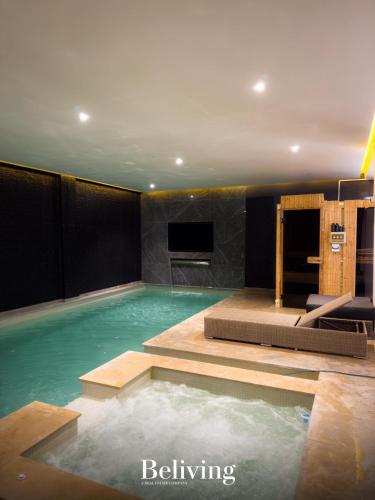 a large swimming pool with a television in a room at Villa Continental 4bedrooms in Tangier