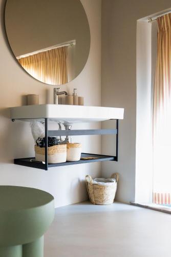 a bathroom with a sink and a mirror at Tenuta Saiano Resort in Torriana