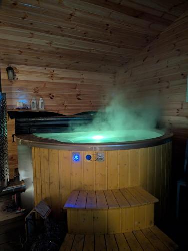 a sauna with a hot tub with steam in it at Leśna Przystań Nowy Kobrzyniec in Kobrzyniec Nowy