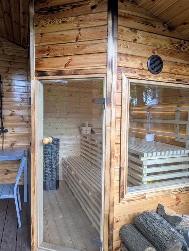 a wooden sauna with a window in a cabin at Leśna Przystań Nowy Kobrzyniec in Kobrzyniec Nowy