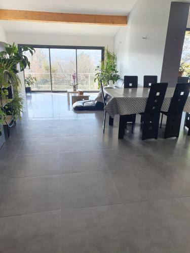 une salle à manger avec une table et des chaises dans l'établissement Villa contemporaine tout confort, à Saint-Julien-de-Peyrolas