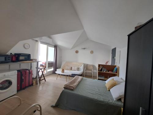 a bedroom with a bed and a living room at Grand studio varangue lagon La Saline in Saint-Paul