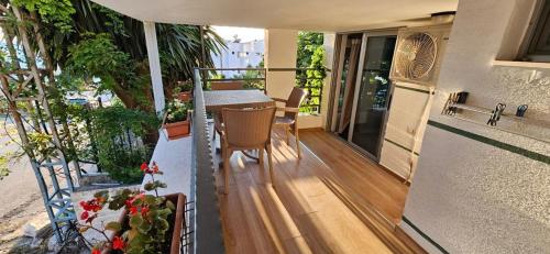 a balcony of a house with a table and chairs at Roan Apartments in Sarandë