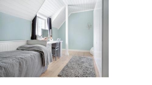 a bedroom with a desk and a bed with a rug at Charming Villa Apartment in Kauniainen