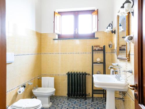 a bathroom with a toilet and a sink at Villa Carolina Sorrento Private Heated Pool and Sea View in Sorrento