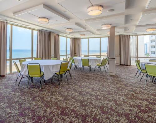 a conference room with tables and chairs and the ocean at Holiday Inn & Suites Virginia Beach - North Beach by IHG in Virginia Beach