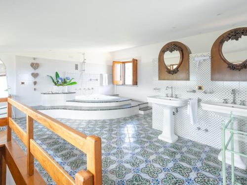a bathroom with two sinks and a tub and a bath tub at Villa Carolina Sorrento Private Heated Pool and Sea View in Sorrento