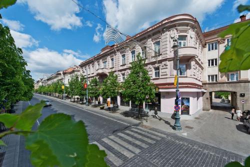 an empty street in a city with a building at 15th Avenue in Vilnius