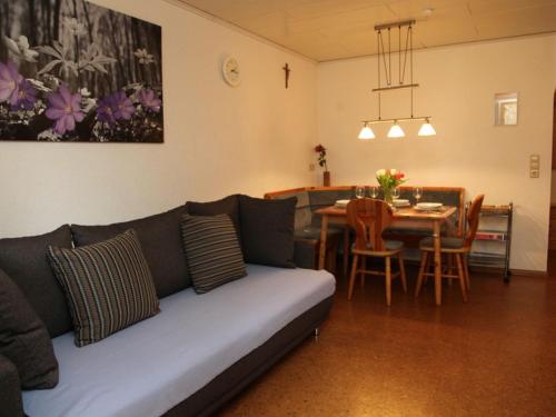 a living room with a couch and a table at Geigerbauernhof in Mühlenbach